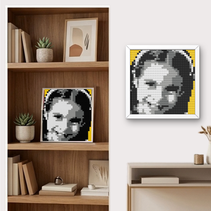 Finished Bricky Cam Pix girl hero pixel art mosaic hanging on a wall and displayed on a shelf